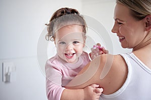 Mother teaching happy girl dental hygiene, baby toothbrush and mom holding kid. Clean teeth, home healthcare and