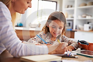 Mother teaching her daughter at home