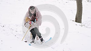 Mother teaching her daughter to ski in winter park
