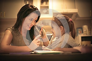 Mother teaching her little girl to draw. Close up.