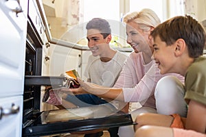 Mother teaching her sons how to bake