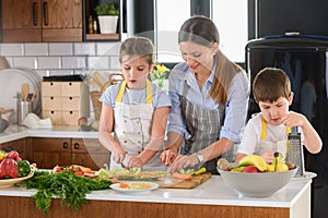 Mother Teaching Kids to Cook and Help in the Kitchen