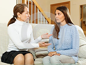 Mother with teen daughter having serious talking