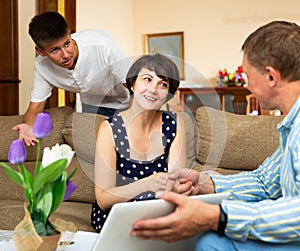 Mother and teen son with bank employee at home