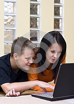 Mother and teenage boy with laptop