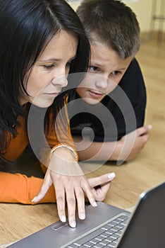 Mother and teenage boy with laptop