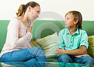 Mother with teenager son having serious conversation