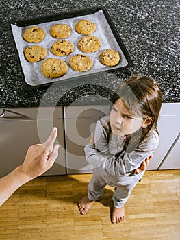 Mother telling daughter that she cannot have cookies