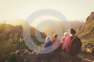 Mother with three kids hiking in mountains