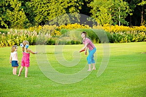 Mother throwing frisbee photo