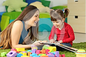 Mother and toddler playing with a book photo