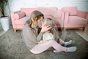 Mother and toddler playing together in the bedroom at home. Maternal love, parenting, joy and parental love for the child