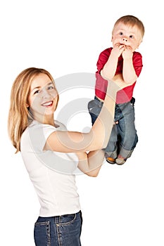 Mother tossing up amazed child