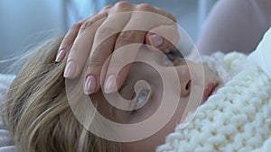 Mother touching sick little daughter forehead, checking body temperature level