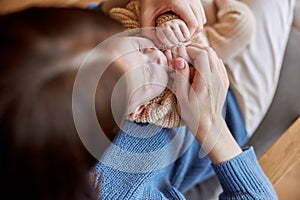 Mother touching small hands of her newborn baby