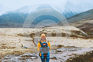 Mother traveling with baby carrier hiking family healthy lifestyle