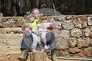 Mother and twin girls in garden