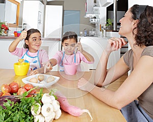 Mother and Twins Beating Eggs in Kitchen