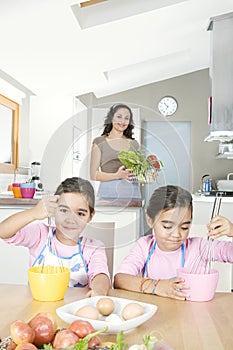 Mother and Twins Beating Eggs in Kitchen