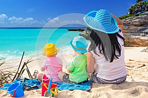 Mother with twins on the tropical beach holidays photo