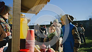 Mother with two children buying watermelon