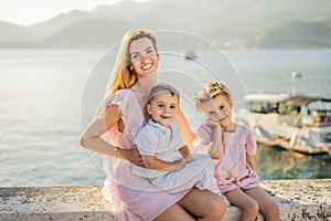 Mother and two children daughter and son tourists on background of beautiful view St. Stephen island, Sveti Stefan on