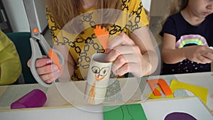 Mother with two children engaged in handcrafts.