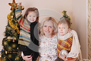 Mother and two children having fun at Christmas time