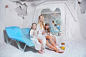 Mother with two children in salt room. Halotherapy for treatment