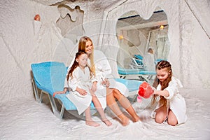 Mother with two children in salt room. Halotherapy for treatment