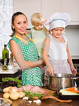 Mother with two daughters cooking