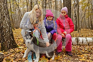 Mother and two daughters with dog breed husky photo