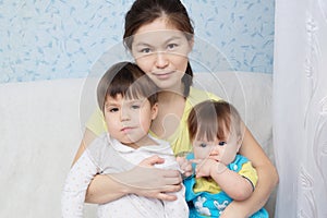 Mother with two daughters, multinational family with Asian mom and little girls