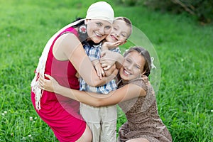 Mother with two kids having picnic outdoors