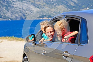Mother with two kids travel by car