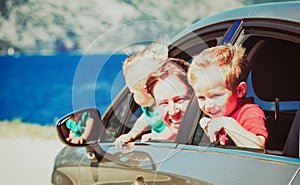 Mother with two kids travel by car on sea vacation