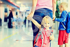 Mother and two kids walking in the airport