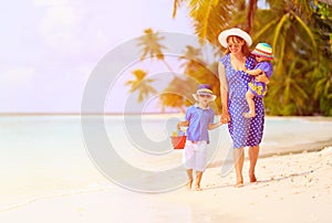 Mother and two kids at walking on beach