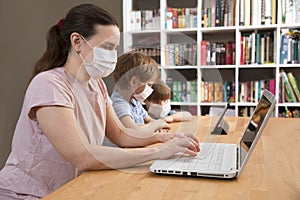 Mother and two kids wearing medical face mask  together at home.