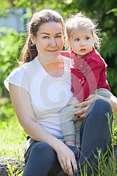 Mother with two-year-old daughter in her arms, portrait