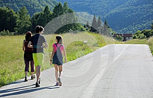 Mother with two young children while walking