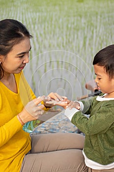 A mother uses antiseptics for her son