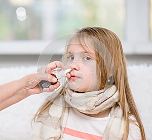 Mother using nose spray to cure her teen girl