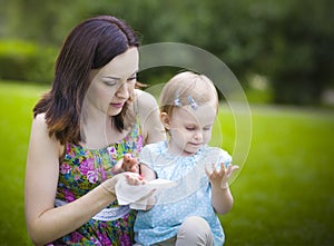 Mother using wet wipes for her daughter