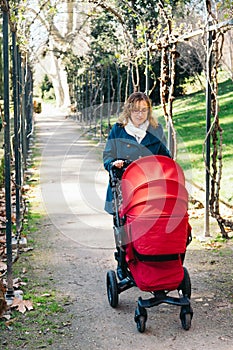 Mother walking with baby stroller