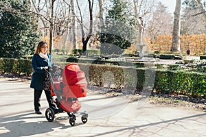 Mother walking with baby stroller