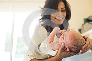 Mother washing baby in bath tub