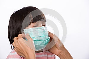 Mother wearing medical mask protection for her daughter