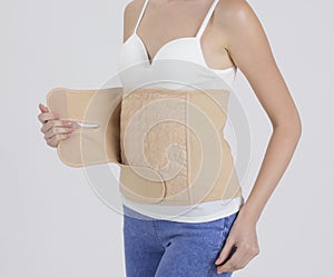 Mother wearing obsterical support belt photo