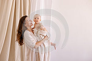 Mother in white clothes kiss a baby. Purity innocence sanctity of motherhood.